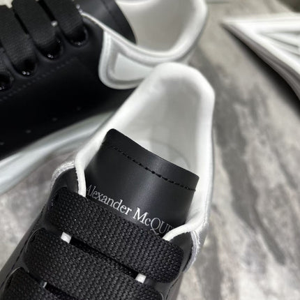 OVERSIZED SNEAKER IN BLACK CALFSKIN WITH SILVER STITCHED WHITE HEEL TAB