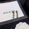 GUCCI 26S DOUBLE G LOGO PINK CRYSTAL FLORAL DROP EARRINGS IN AGED GOLD TONE METAL 629030