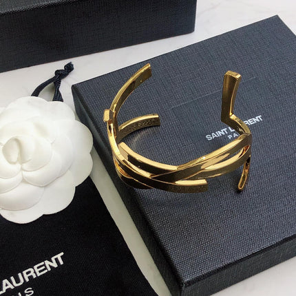 YSL 26S CRISS CROSS OPEN CUFF BRACELET IN GOLD TONE METAL 635064