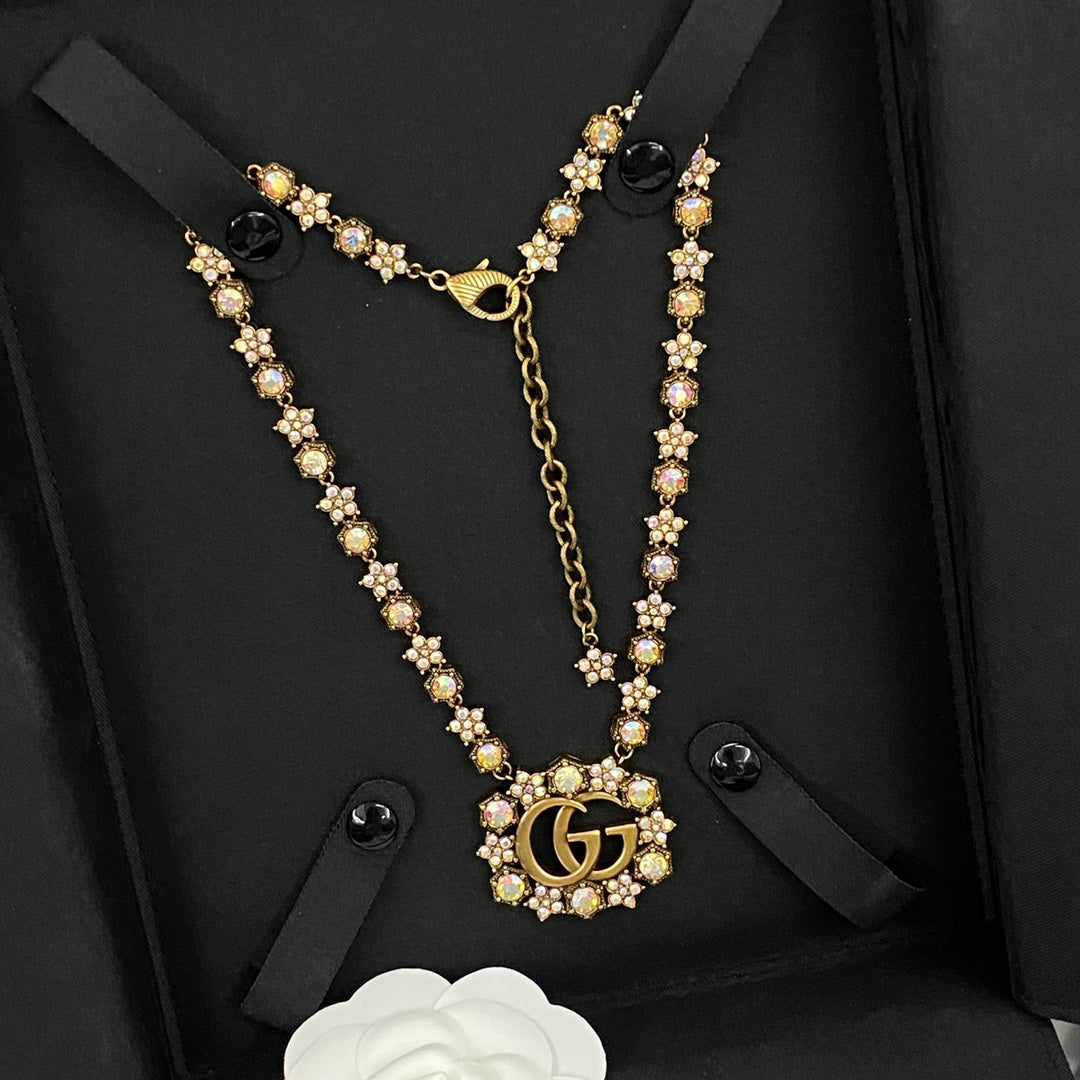 GUCCI 26S INTERLOCKING GG CRYSTAL FLORAL LINK NECKLACE IN ANTIQUE GOLD TONE METAL 620394