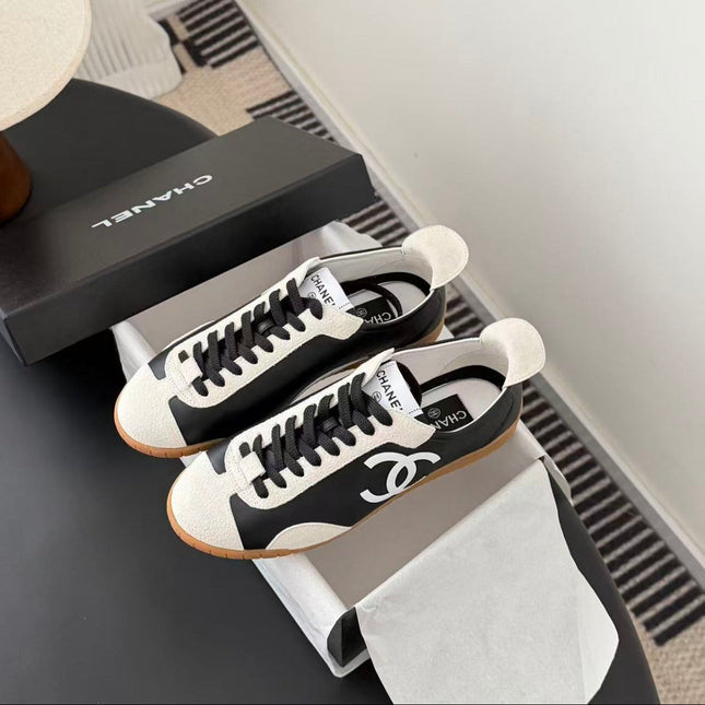 CHANEL TRAINERS IN BLACK AND WHITE CALFSKIN AND EMBOSSED SUEDE CALFSKIN