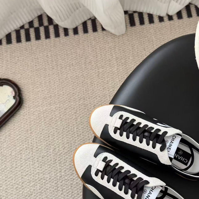 CHANEL TRAINERS IN BLACK AND WHITE CALFSKIN AND EMBOSSED SUEDE CALFSKIN