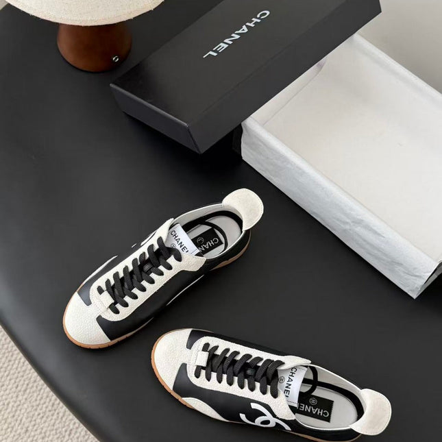 CHANEL TRAINERS IN BLACK AND WHITE CALFSKIN AND EMBOSSED SUEDE CALFSKIN