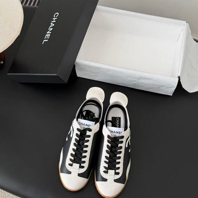 CHANEL TRAINERS IN BLACK AND WHITE CALFSKIN AND EMBOSSED SUEDE CALFSKIN