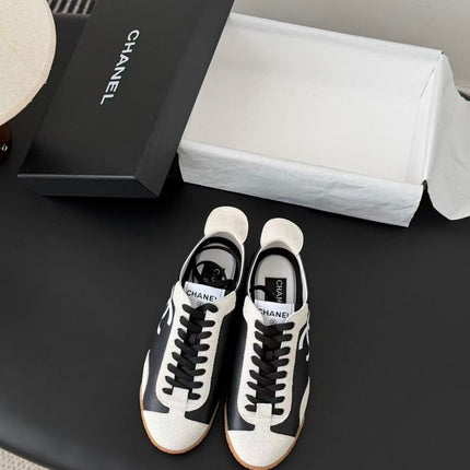 CHANEL TRAINERS IN BLACK AND WHITE CALFSKIN AND EMBOSSED SUEDE CALFSKIN