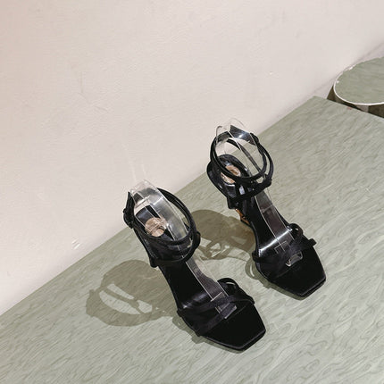 YSL 25S HIGH-HEEL SANDALS 100 MM IN BLACK SATIN WITH YSL LOGO HEEL DESIGN IN GOLD