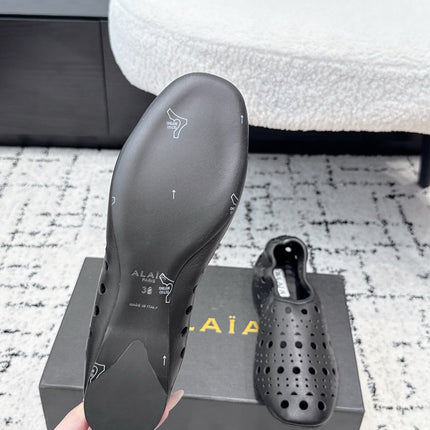 ALAIA 26S FLAT SLIP-ONS IN BLACK CALFSKIN WITH OPENWORK PATTERN