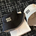 MIUMIU CLASSIC REVERSIBLE BUCKET HAT IN LIGHT BEIGE AND BLACK FABRIC