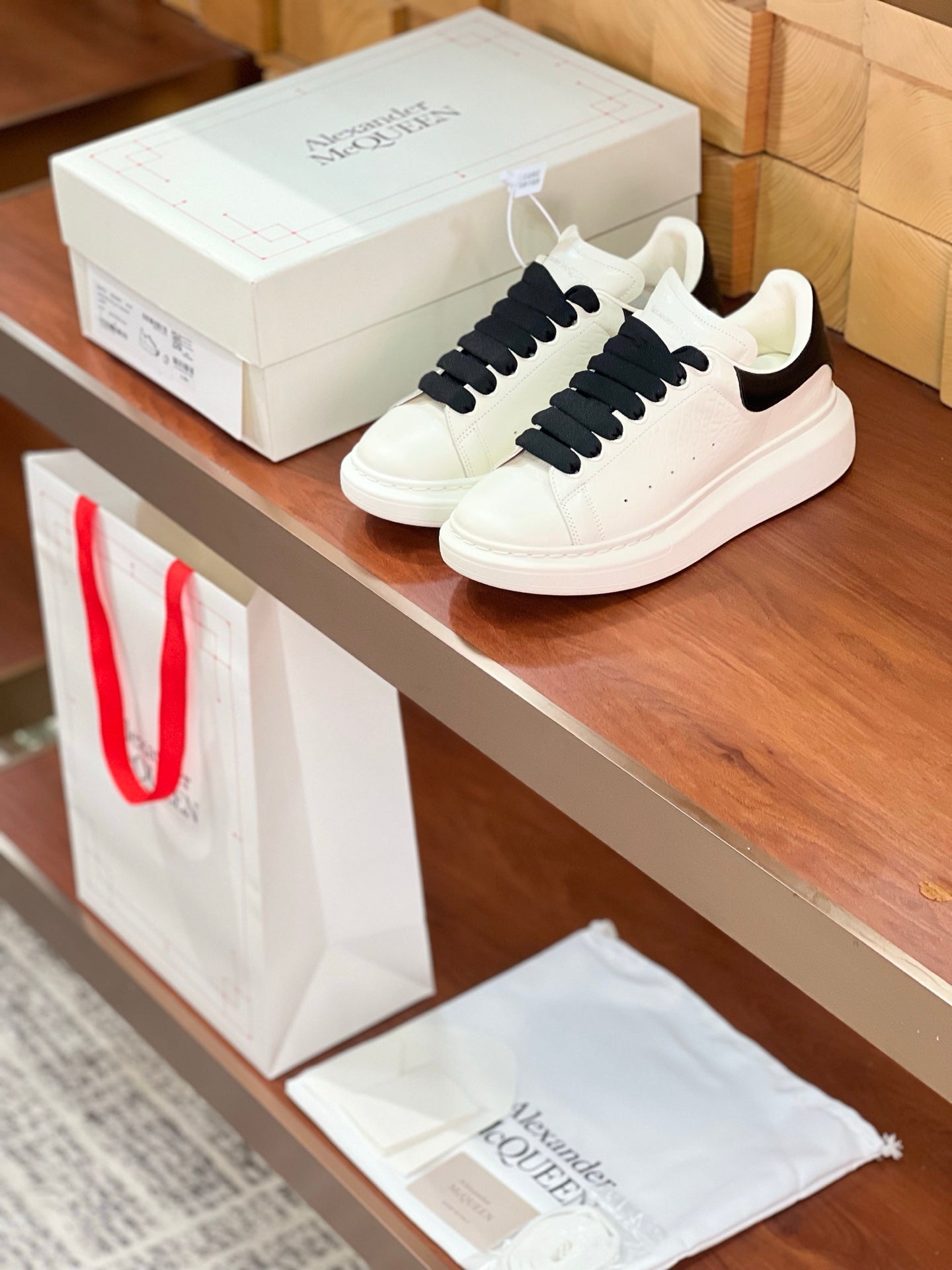 OVERSIZED SNEAKERS IN WHITE CALFSKIN BLACK HEEL BLACK LACES