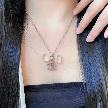 CHANEL 26S DOUBLE C LOGO CLEAR BOW PENDANT NECKLACE IN GOLD METAL 629174