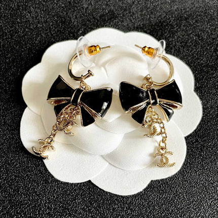 CHANEL 26S DOUBLE C LOGO BLACK ENAMEL BOW DANGLE EARRINGS WITH CHAIN CHARMS IN GOLD METAL 629178