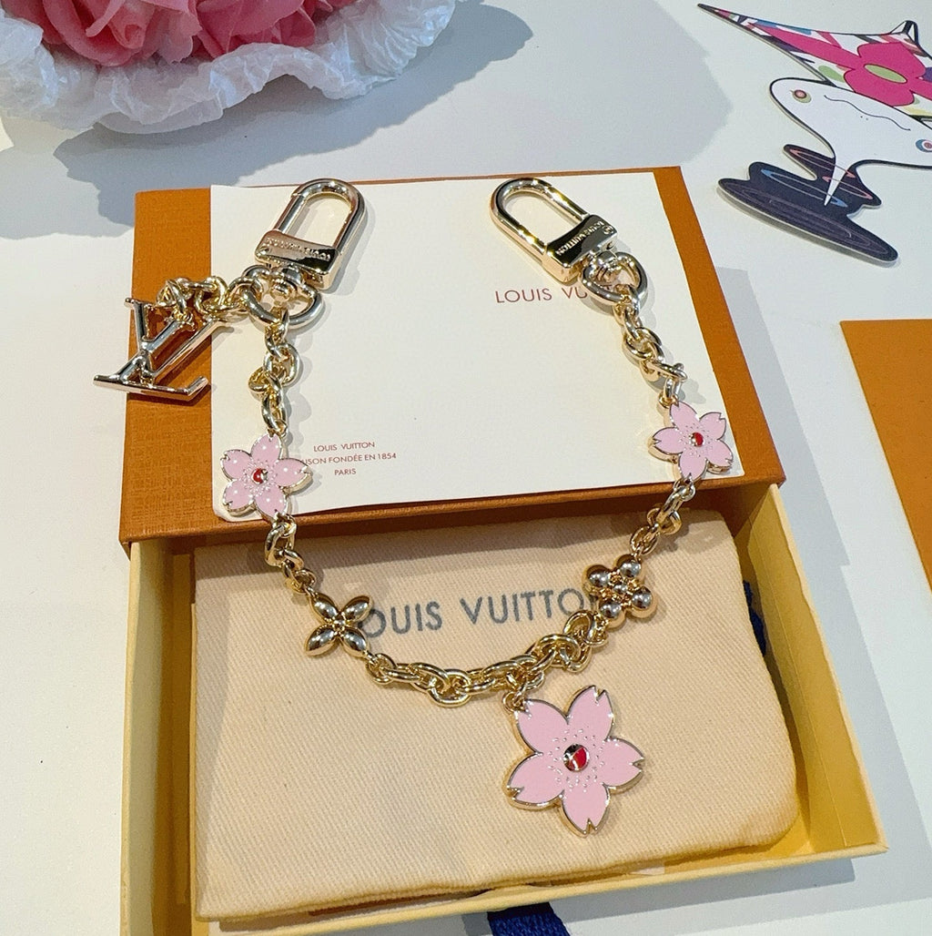 SAKURA BAG CHARM IN GOLD METAL HARDWARE
