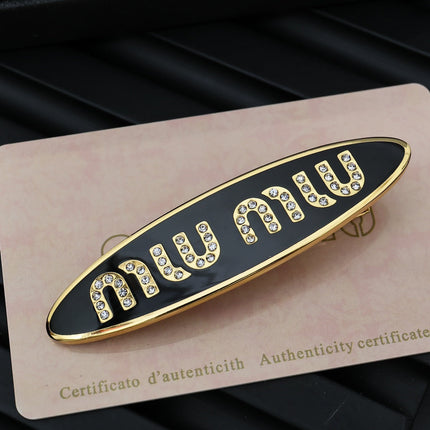 MIUMIU 26S CRYSTAL LOGO HAIR CLIP IN BLACK ENAMEL AND GOLD TONE METAL 626894