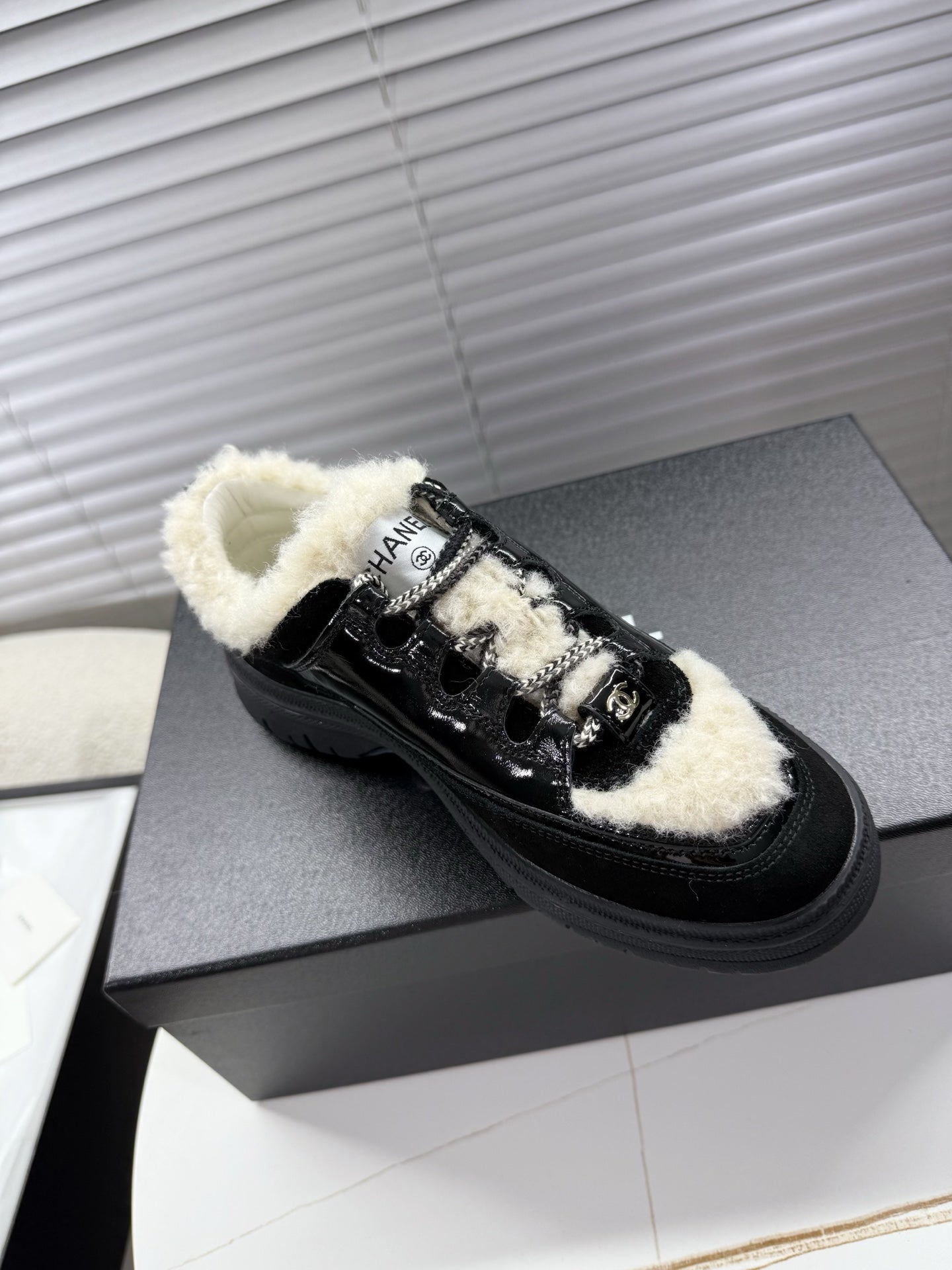 CHANEL 25S SNEAKERS WITH FUR ACCENTS 35MM IN BLACK CALFSKIN