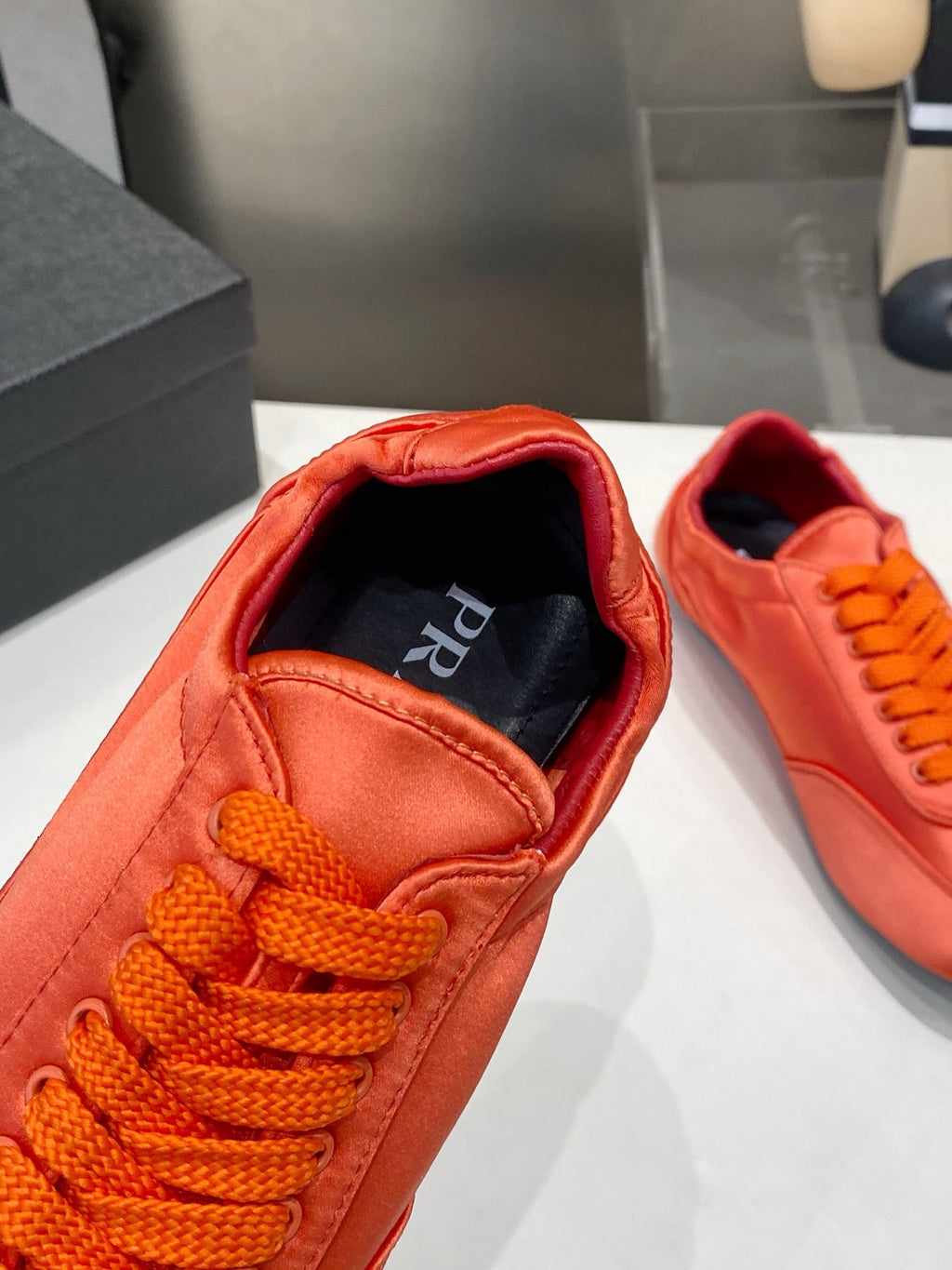 PRADA 26S SNEAKERS IN BURNT ORANGE SATIN