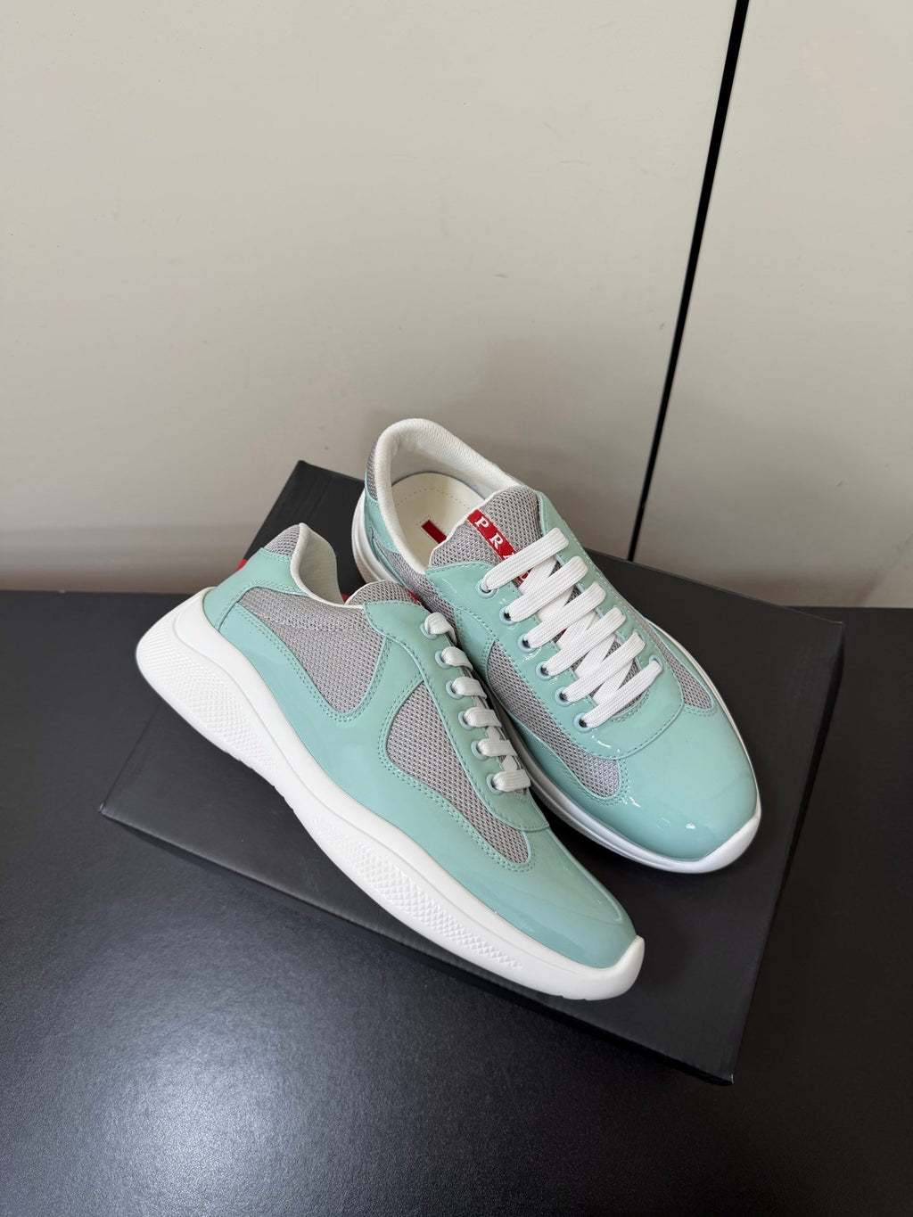 PRADA 26S SNEAKERS IN SOFT TEAL PATENT CALFSKIN AND WHITE MESH