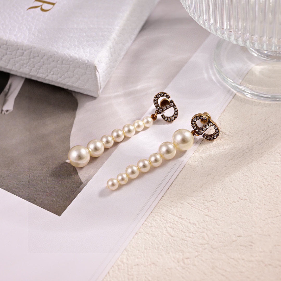 CD 26S PAVE LOGO PEARL DROP EARRINGS IN GOLD TONE METAL 631791