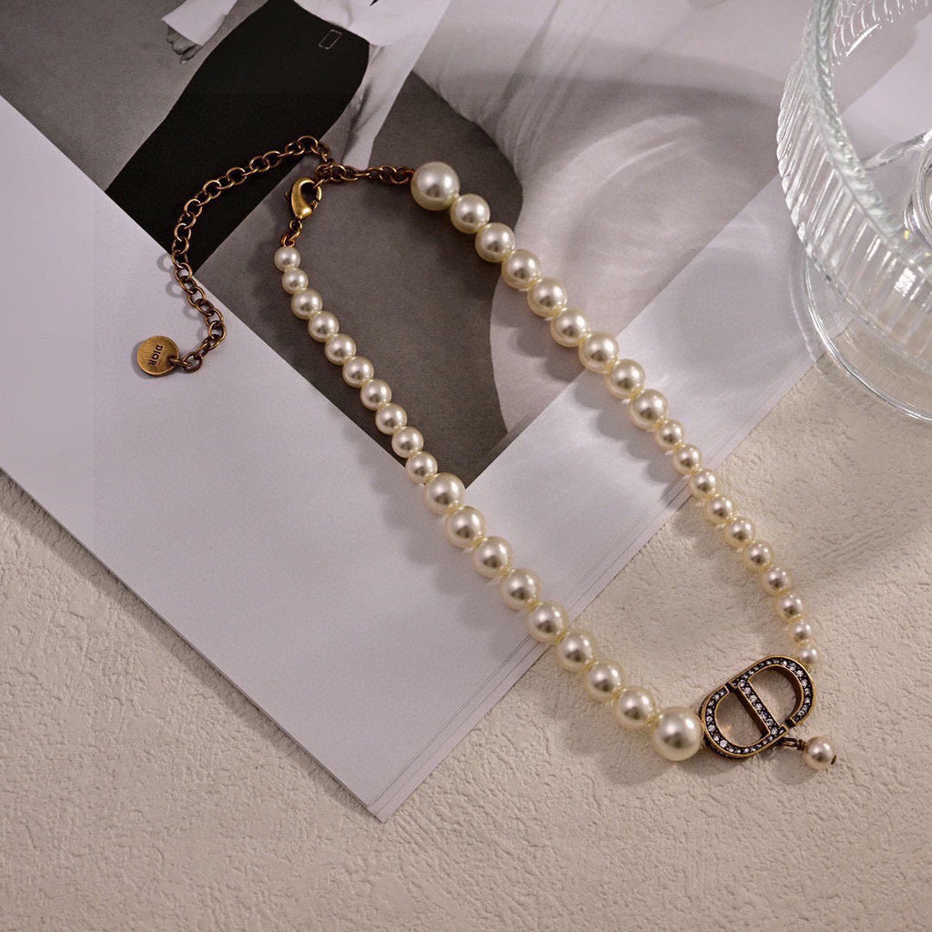 CD 26S PEARL STRAND CD CRYSTAL LOGO DROP NECKLACE IN GOLD TONE METAL 631858