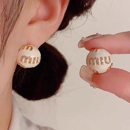 MIUMIU 26S MIU CRYSTAL LOGO STUD EARRINGS IN WHITE ENAMEL AND GOLD TONE METAL 633129