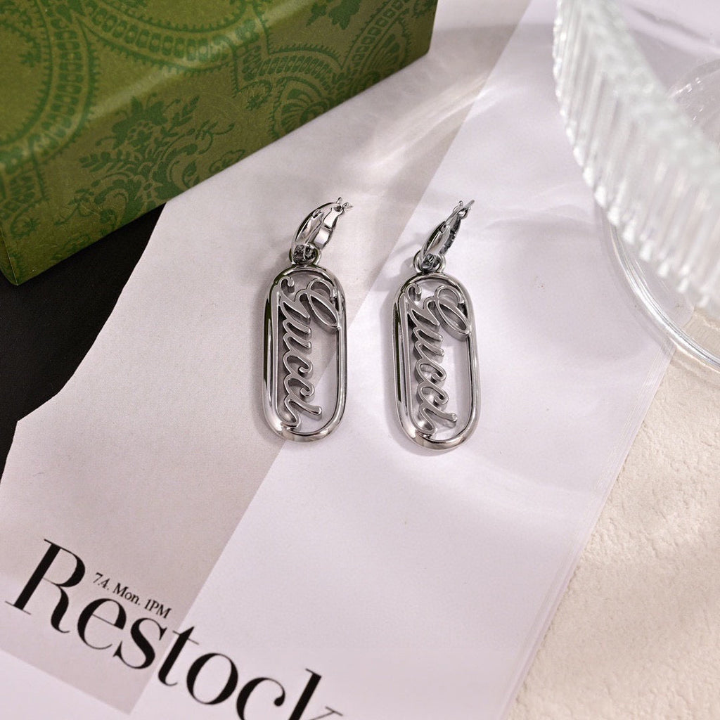GUCCI 26S SCRIPT LOGO OVAL DROP EARRINGS IN SILVER TONE METAL 633780