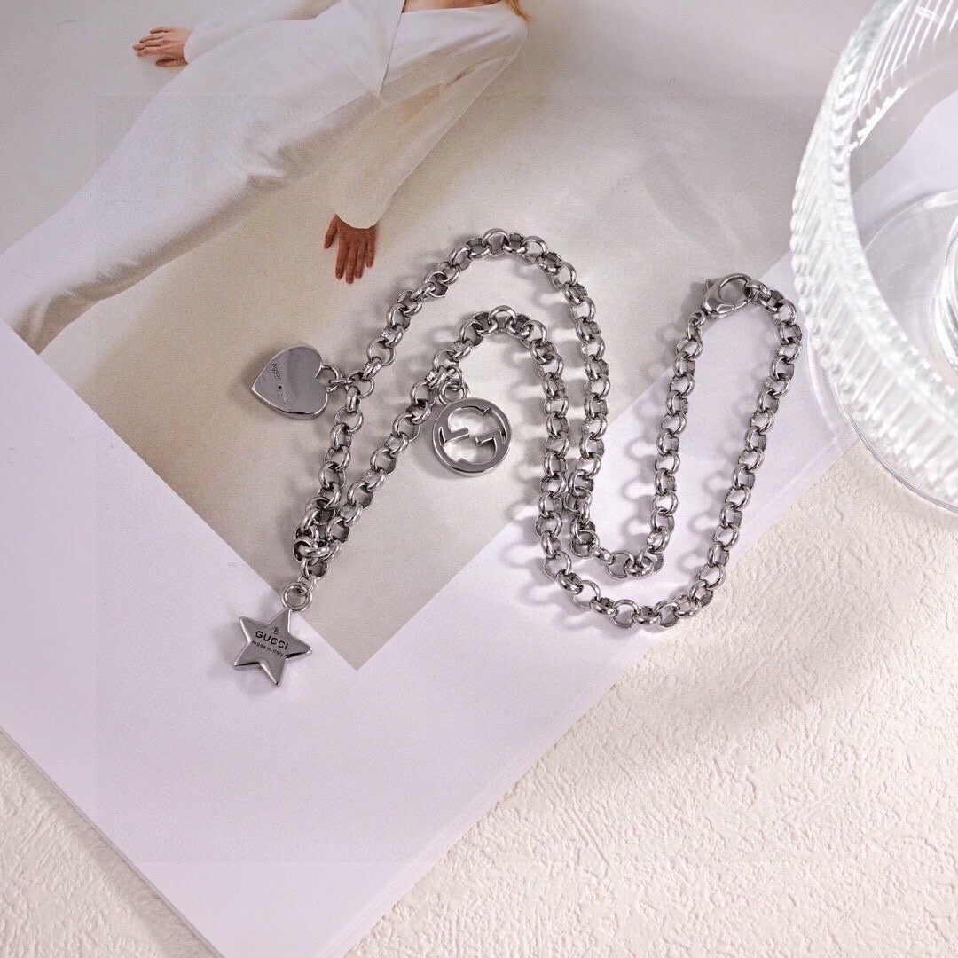 GUCCI 26S INTERLOCKING G LOGO STAR HEART MULTI CHARM CHAIN BRACELET IN SILVER TONE METAL