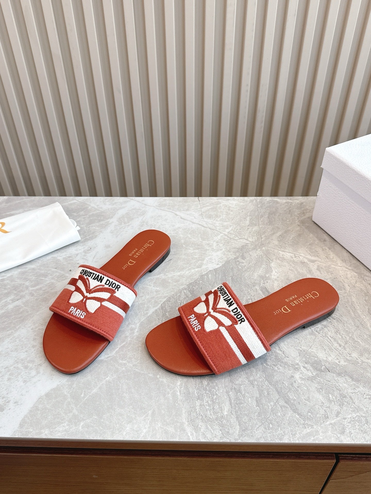 DIOR FLAT SLIDES 25S IN DARK ORANGE CALFSKIN AND FABRIC BRAND NAME EMBROIDERY