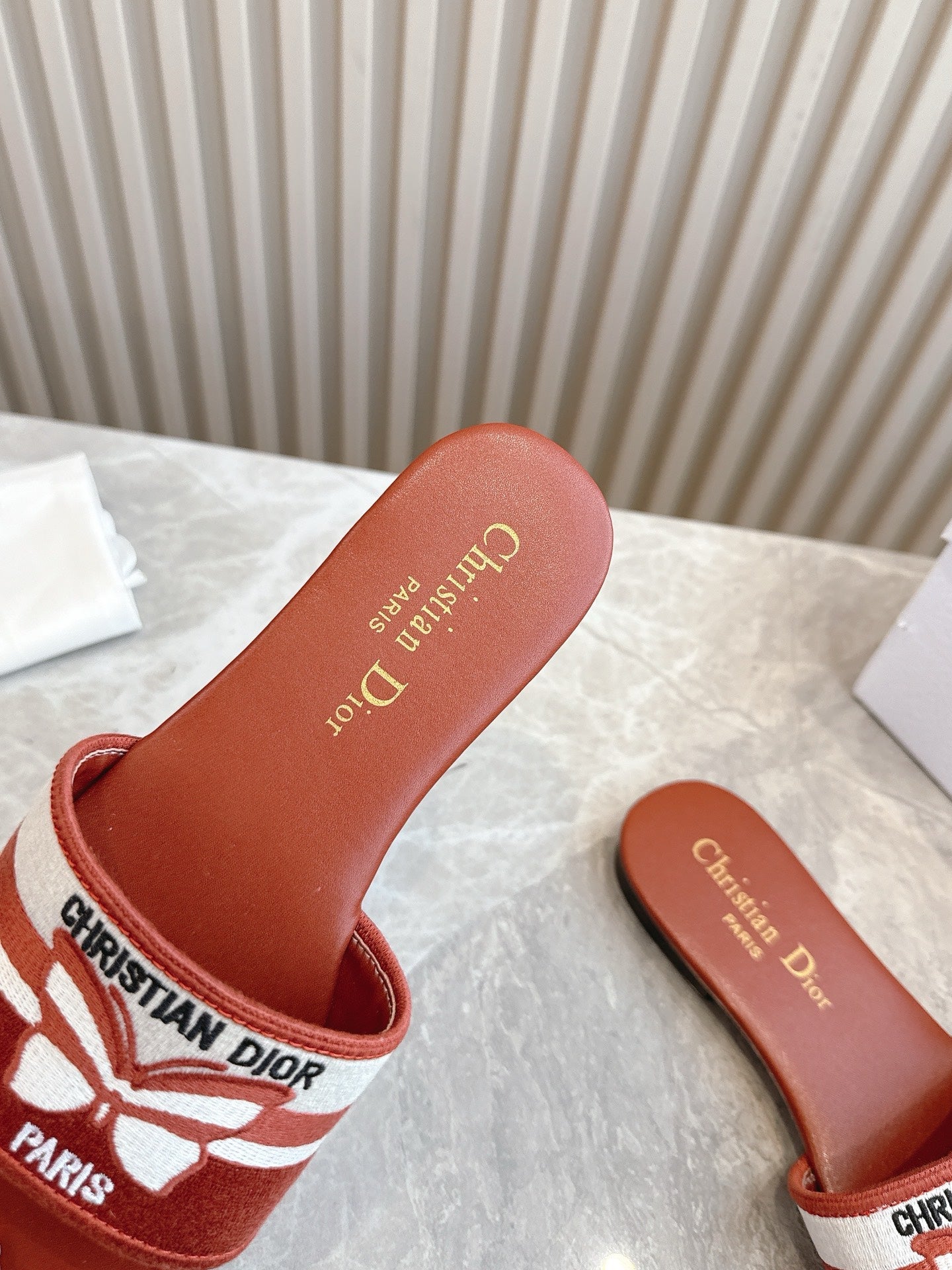 DIOR FLAT SLIDES 25S IN DARK ORANGE CALFSKIN AND FABRIC BRAND NAME EMBROIDERY