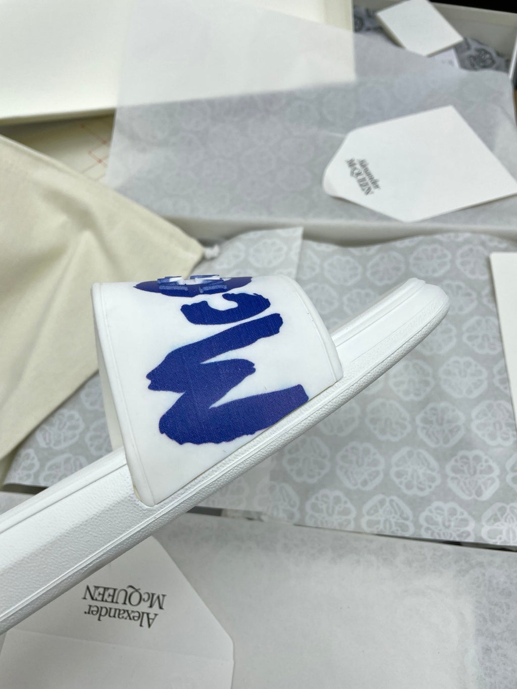SLIDES SANDAL IN WHITE WITH BLUE LOGO GRAPHIC IN STRAP
