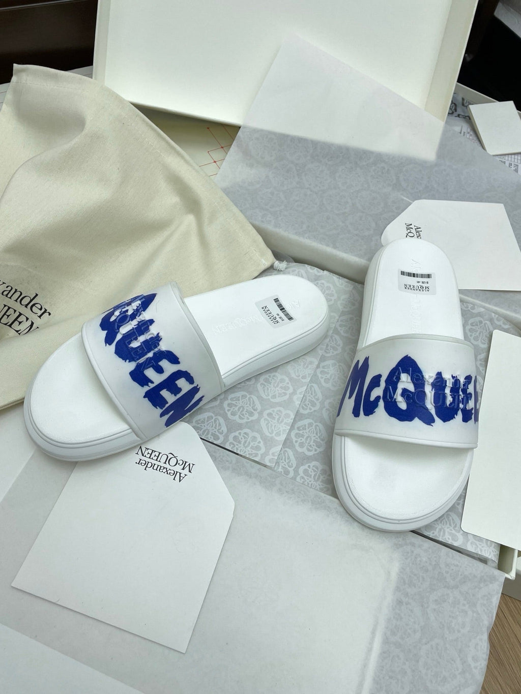 SLIDES SANDAL IN WHITE WITH BLUE LOGO GRAPHIC IN STRAP