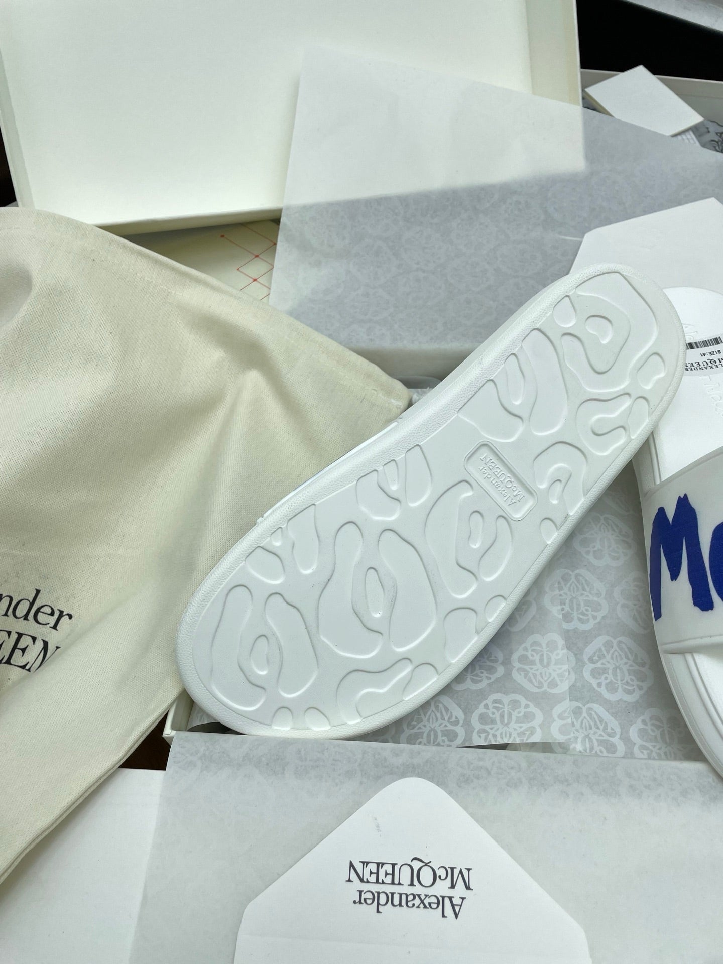 SLIDES SANDAL IN WHITE WITH BLUE LOGO GRAPHIC IN STRAP