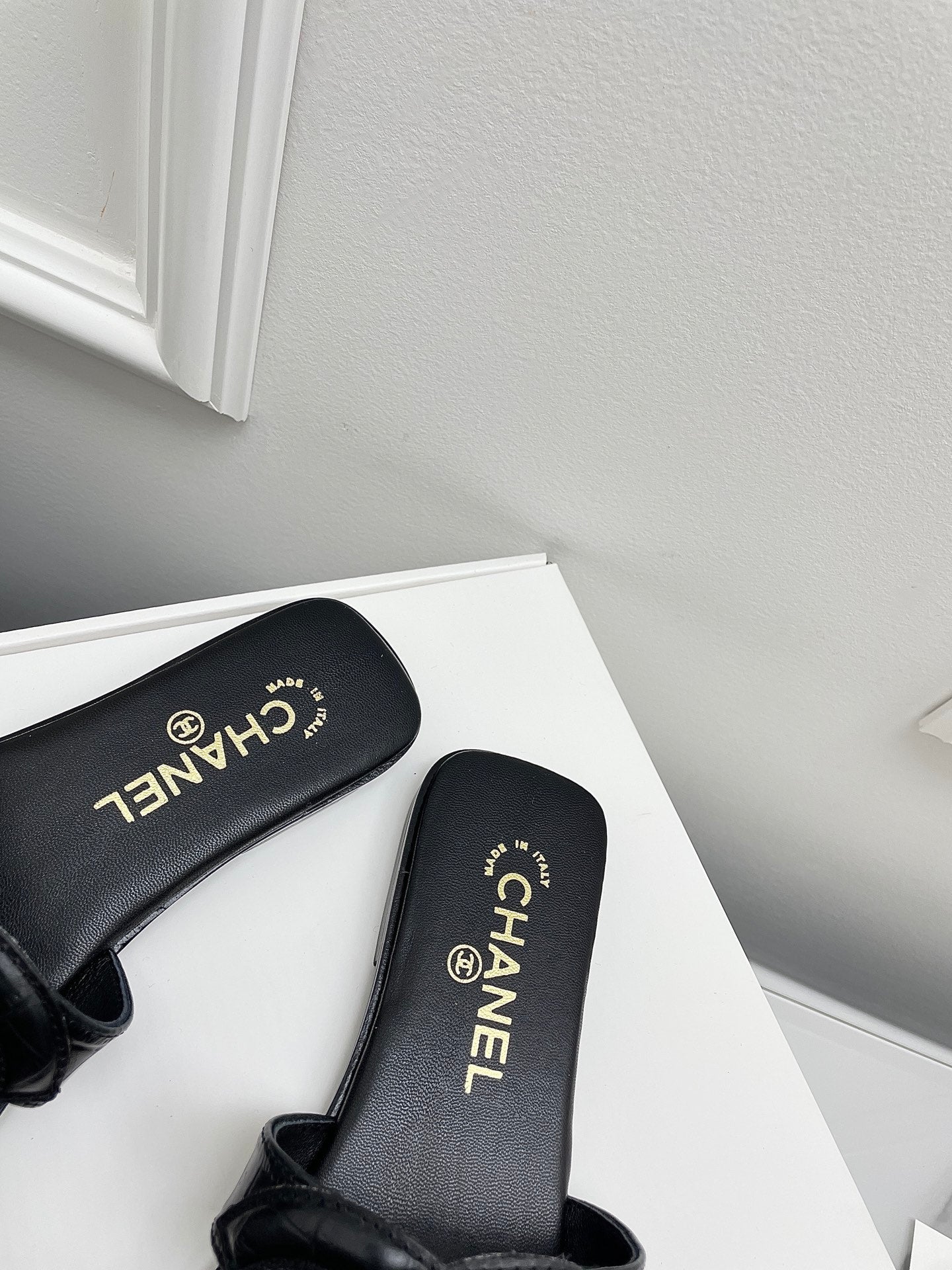 CHANEL CC LOGO MULES IN BLACK CALFSKIN
