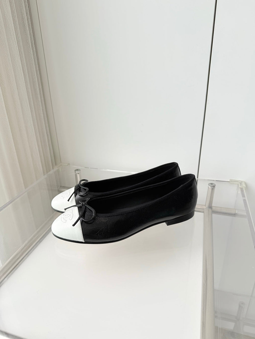 CHANEL 26S BALLET FLATS IN BLACK CRACKED CALFSKIN WITH WHITE TOE CAP AND BOW